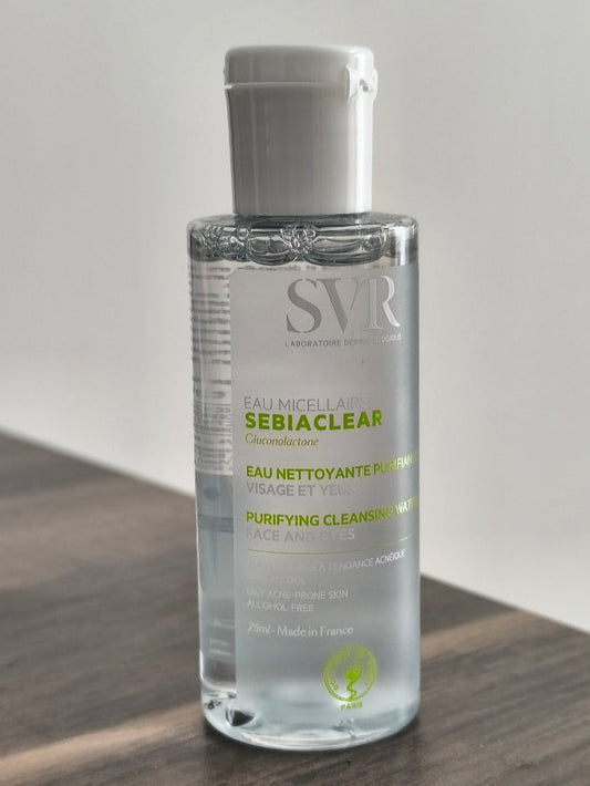 SVR Sebiaclear bottle on a wooden surface with a gray background